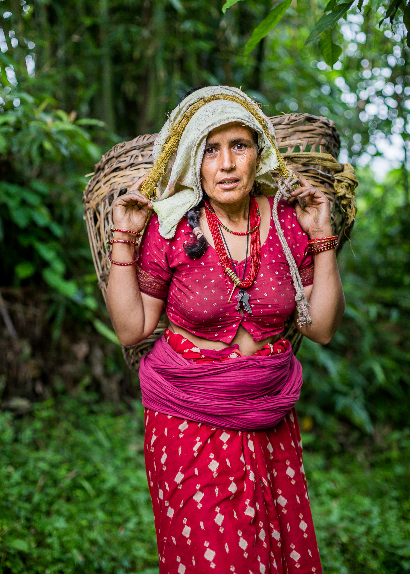 Collecting her baskets after a day’s work in the fields.