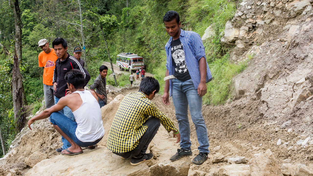 Boys exploring the landslide while other passengers get off the bus. They were realizing that they would have to walk all the way to Baluwa - 3 hours away by foot!