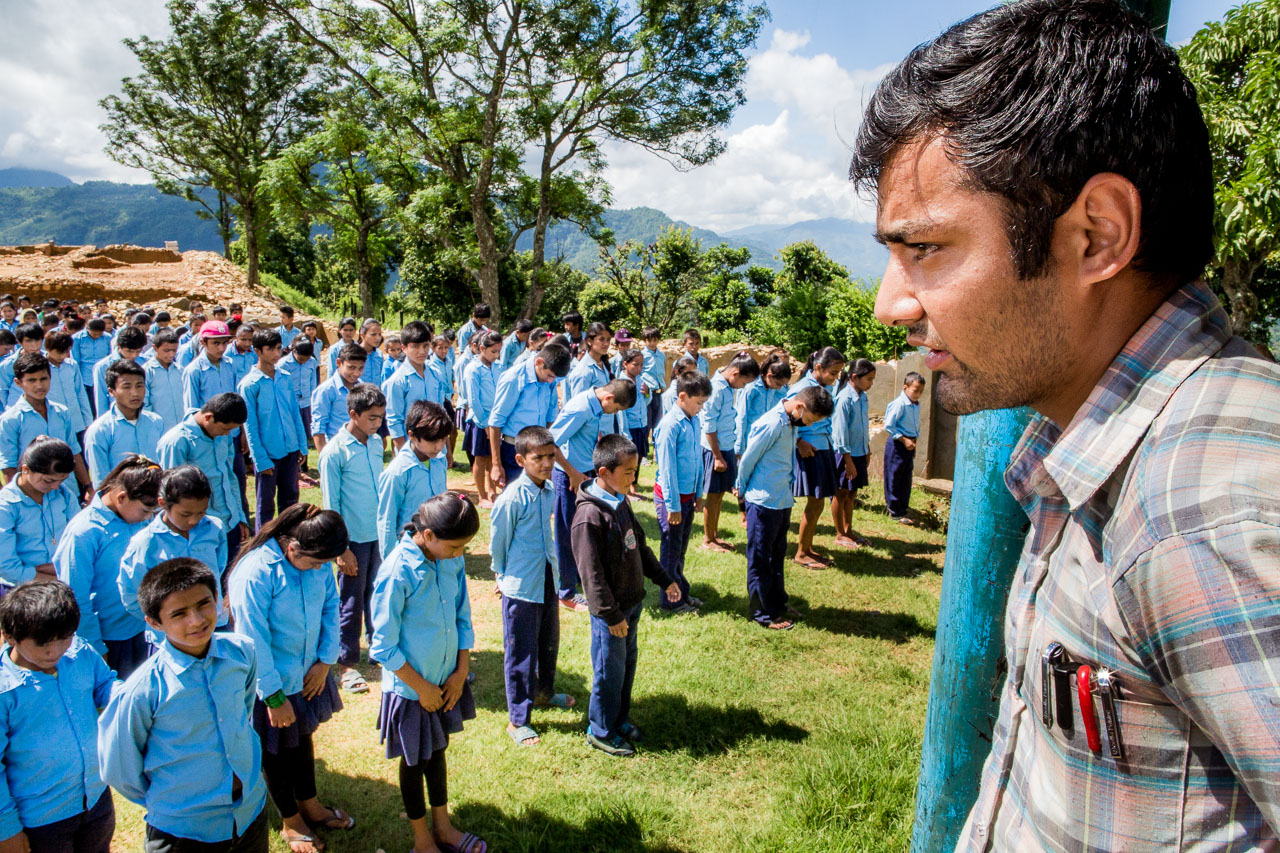 Teacher leading the morning school Assembly.