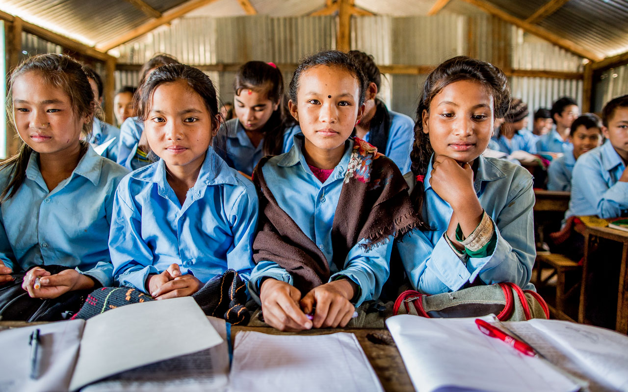 Girls reading from their books.