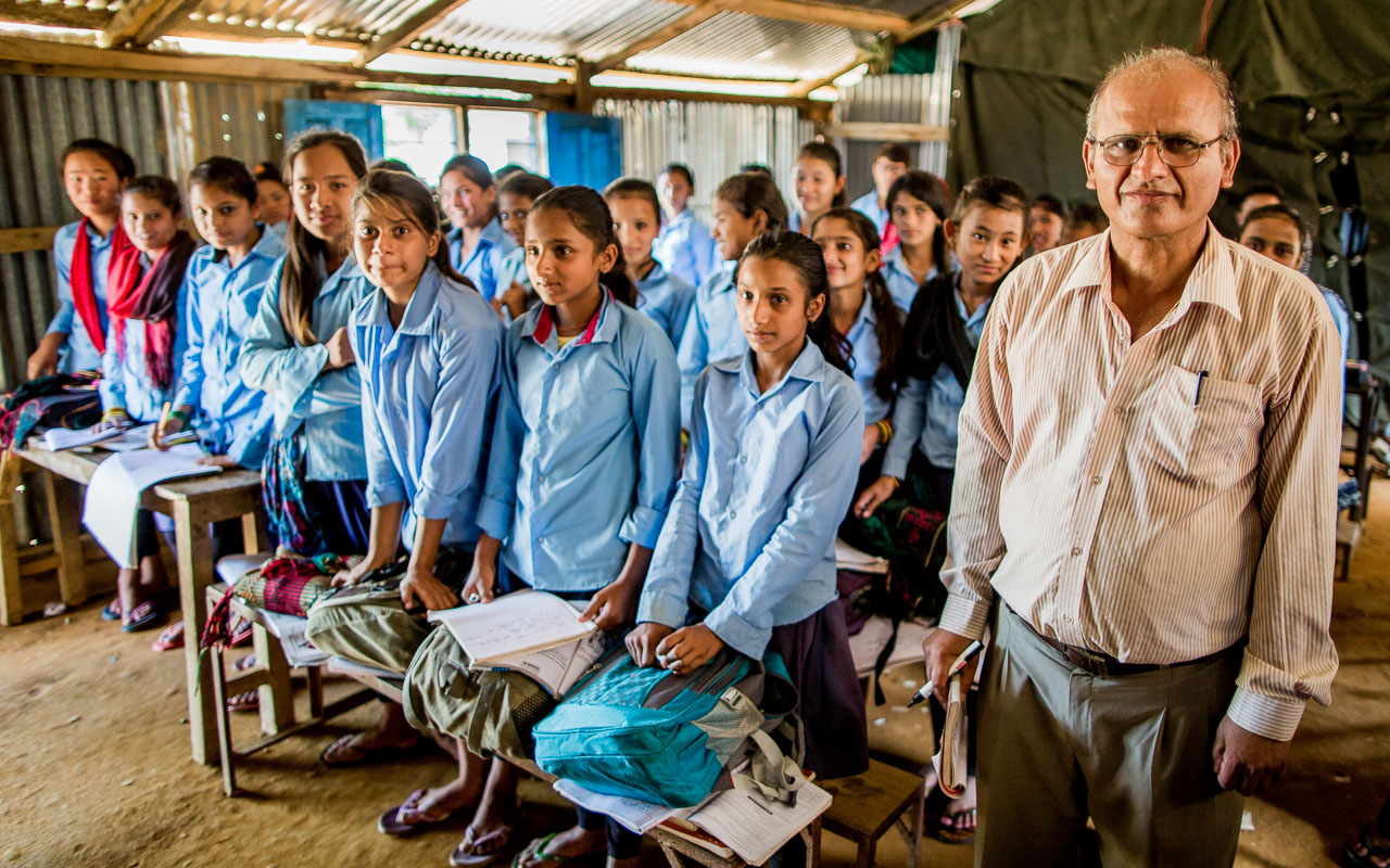Secondary level English teacher with the girls from his class. Boys and girls are taught separately in all governmentschools.