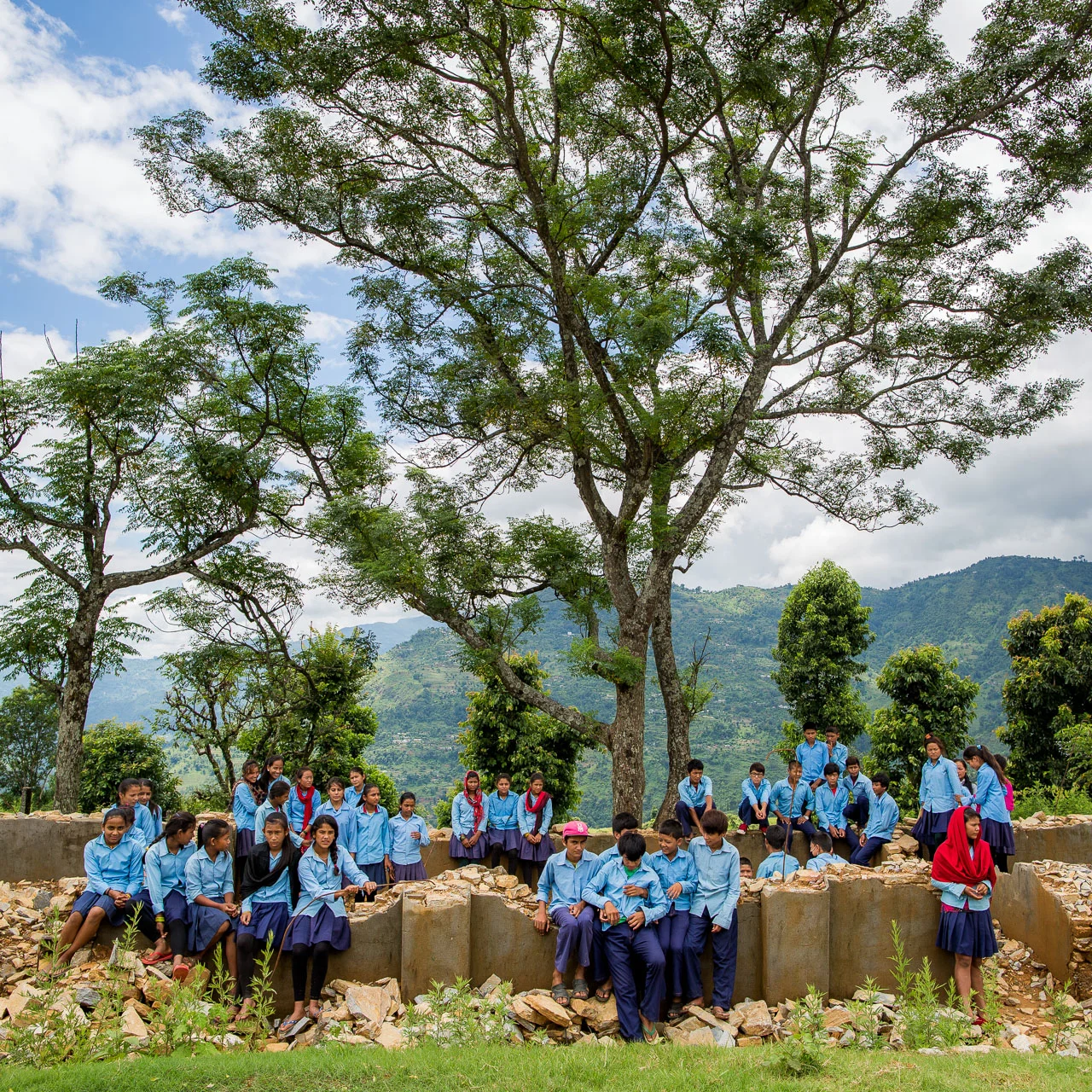 Children from three classes in the ruins of their classrooms. 