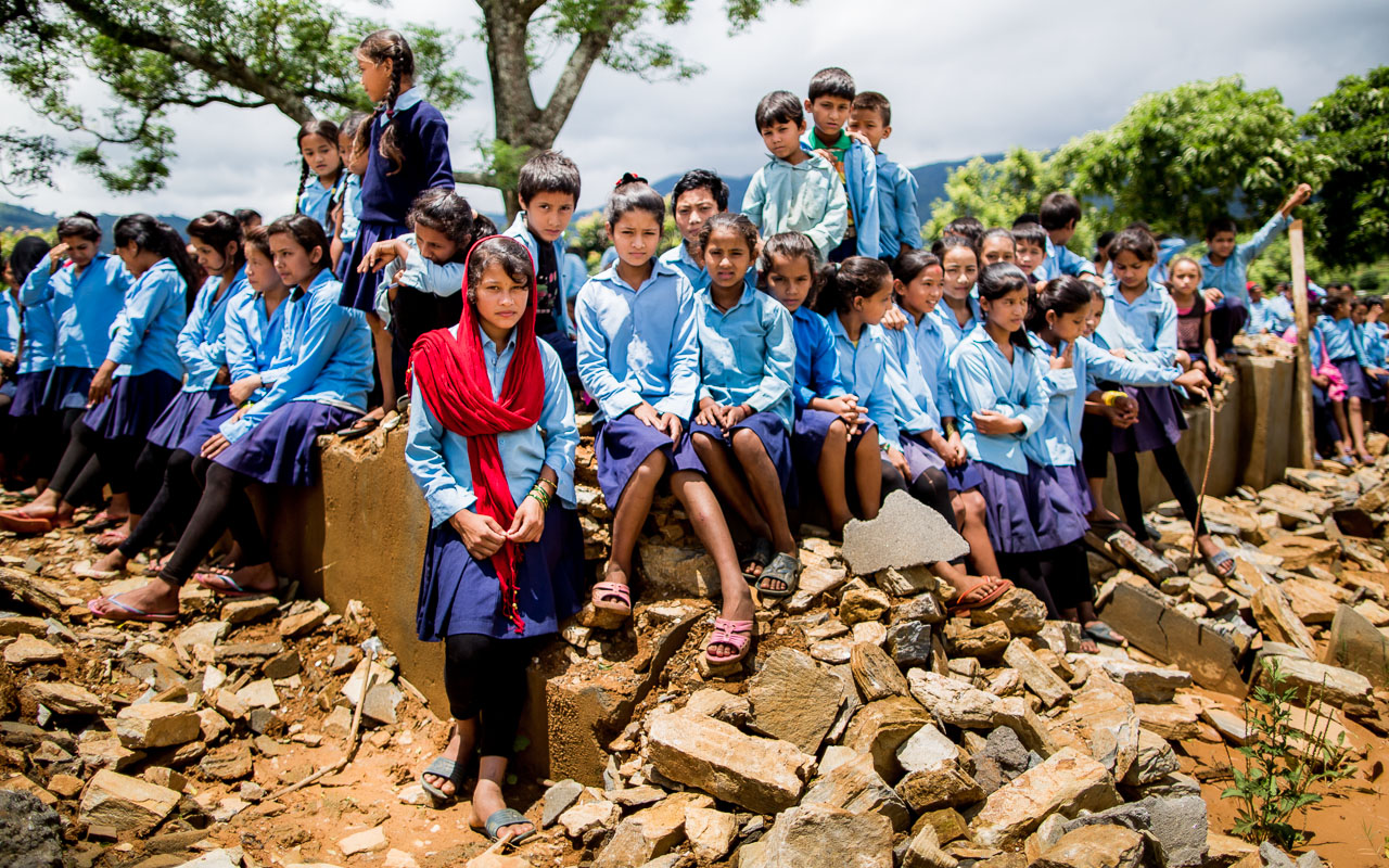 Children in the remains of their classrooms. 