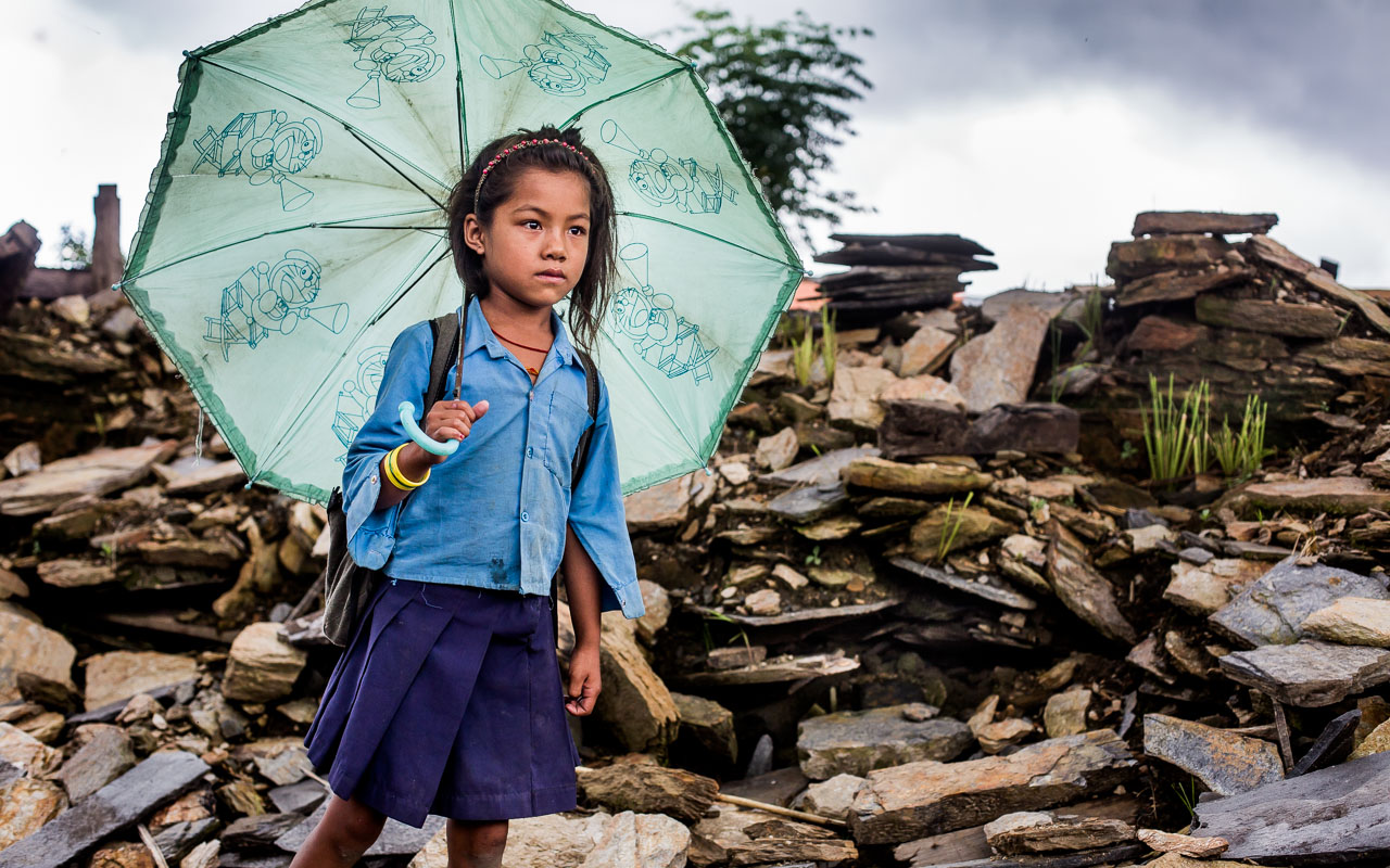 Child passing all that remains of her house every morning going to school and every afternoon returning home. The look on her face shows her feelings…