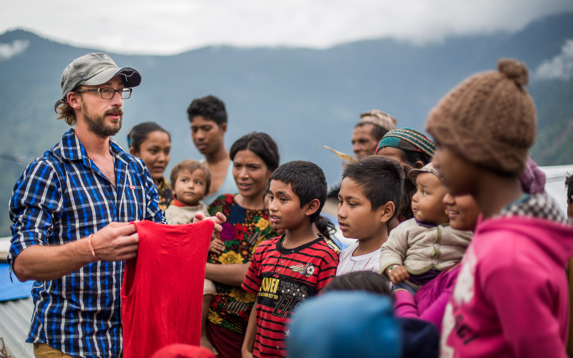 Handing over clothing to a surprised group of Dalit (Untouchable) people in Barpak. 