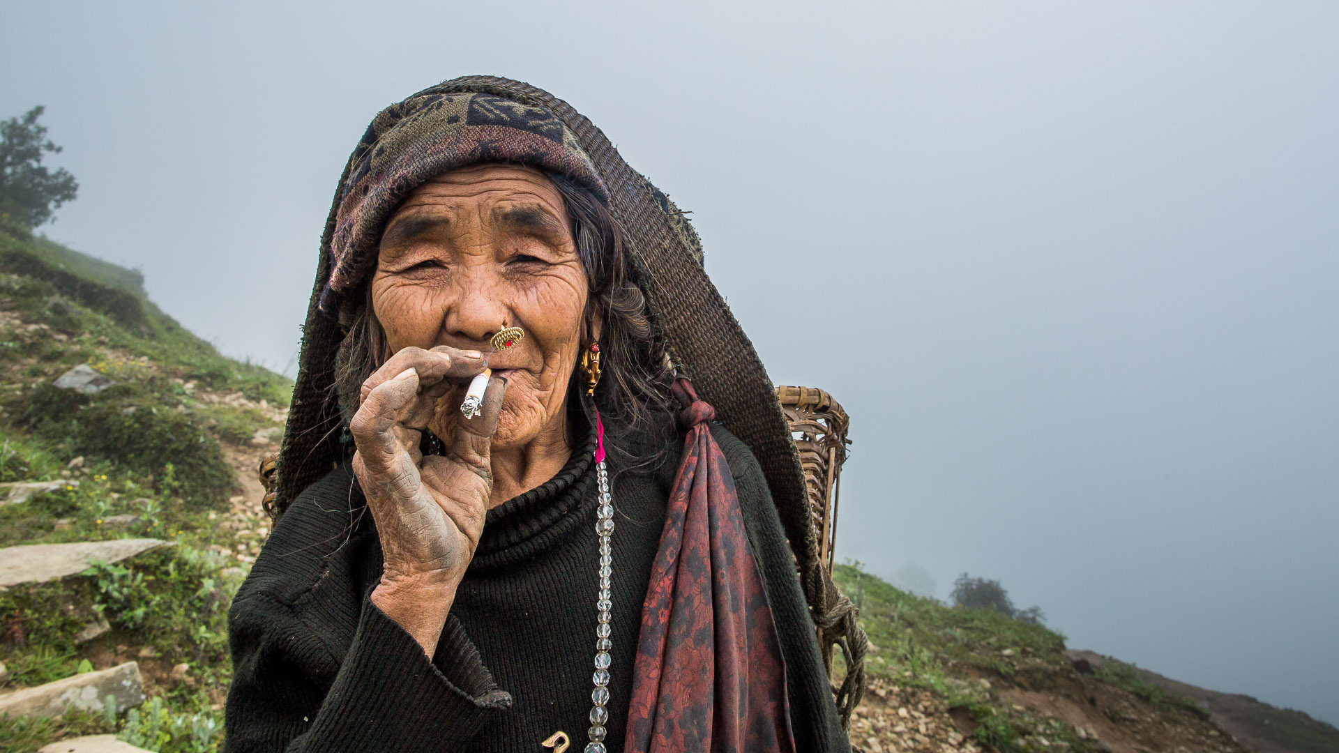 Gurung lady smoking a cigarette.
