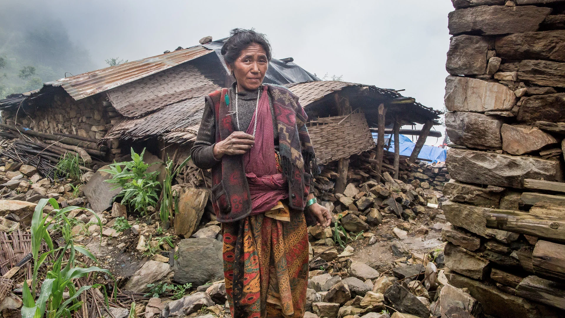  Lady at the ruins of her house in 'old' Laprak. 