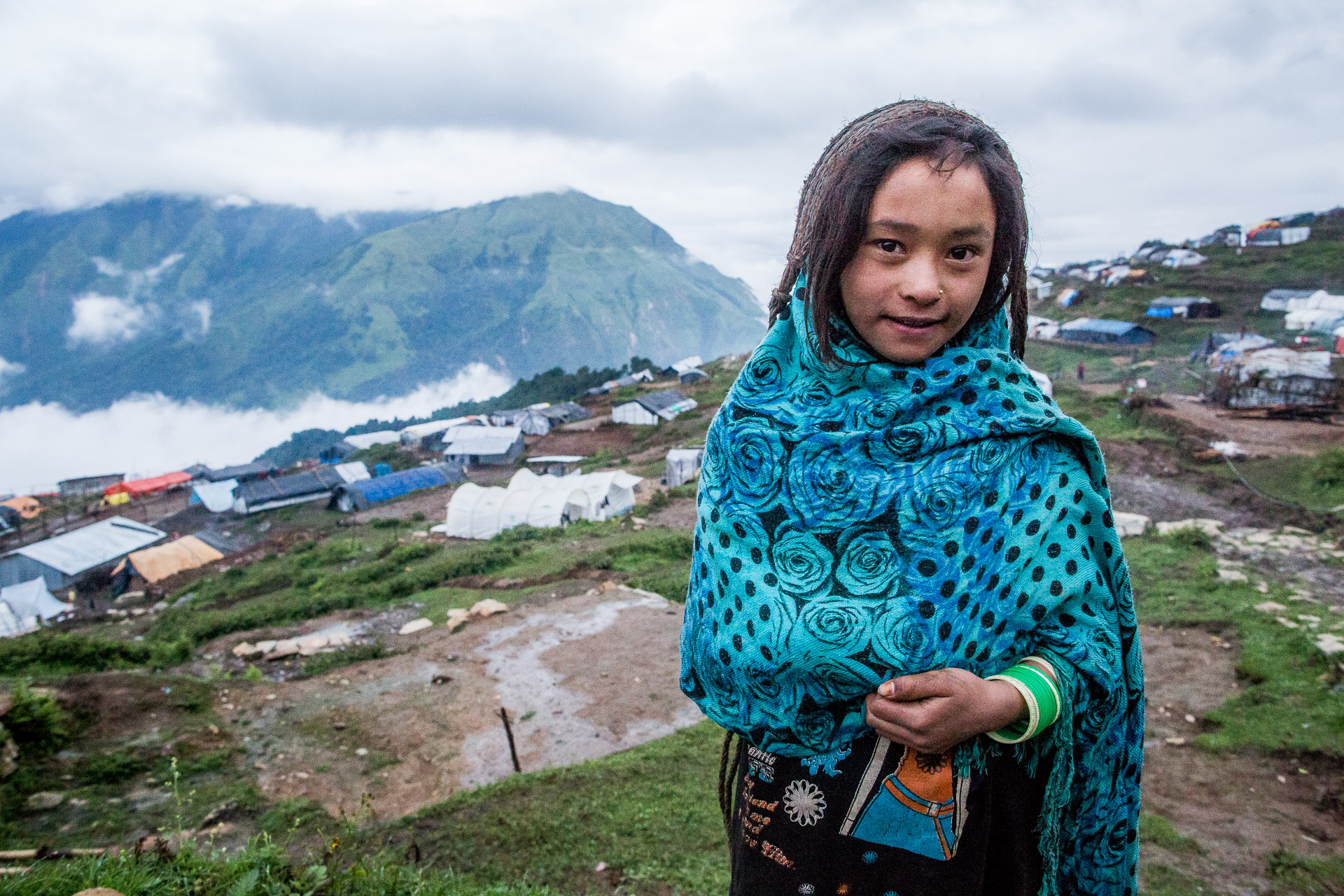 Child close to her plastic house on the top of the hill where ''new' Laprak is situated.