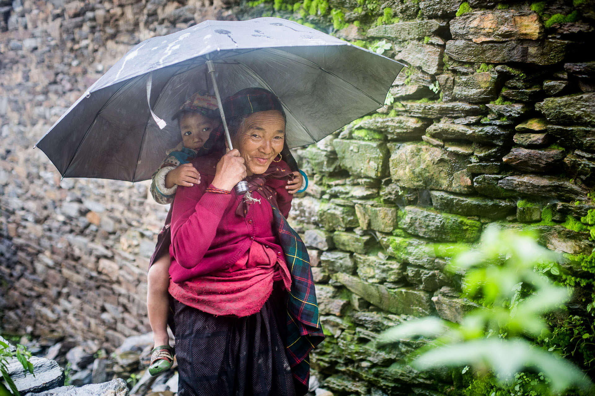 Grandmother with her grandson walking on their way to the ruins of old Barpak. 