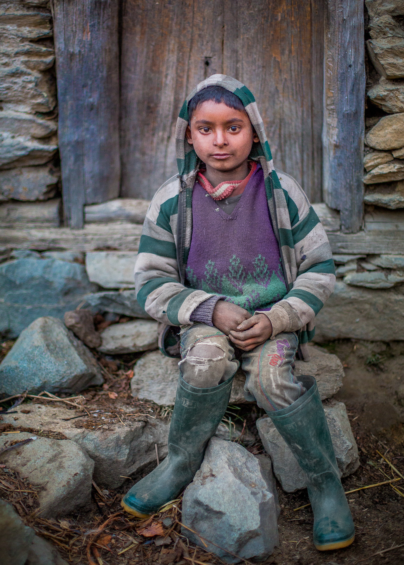 Sumit Tamara sitting infront of his house in Sitola.