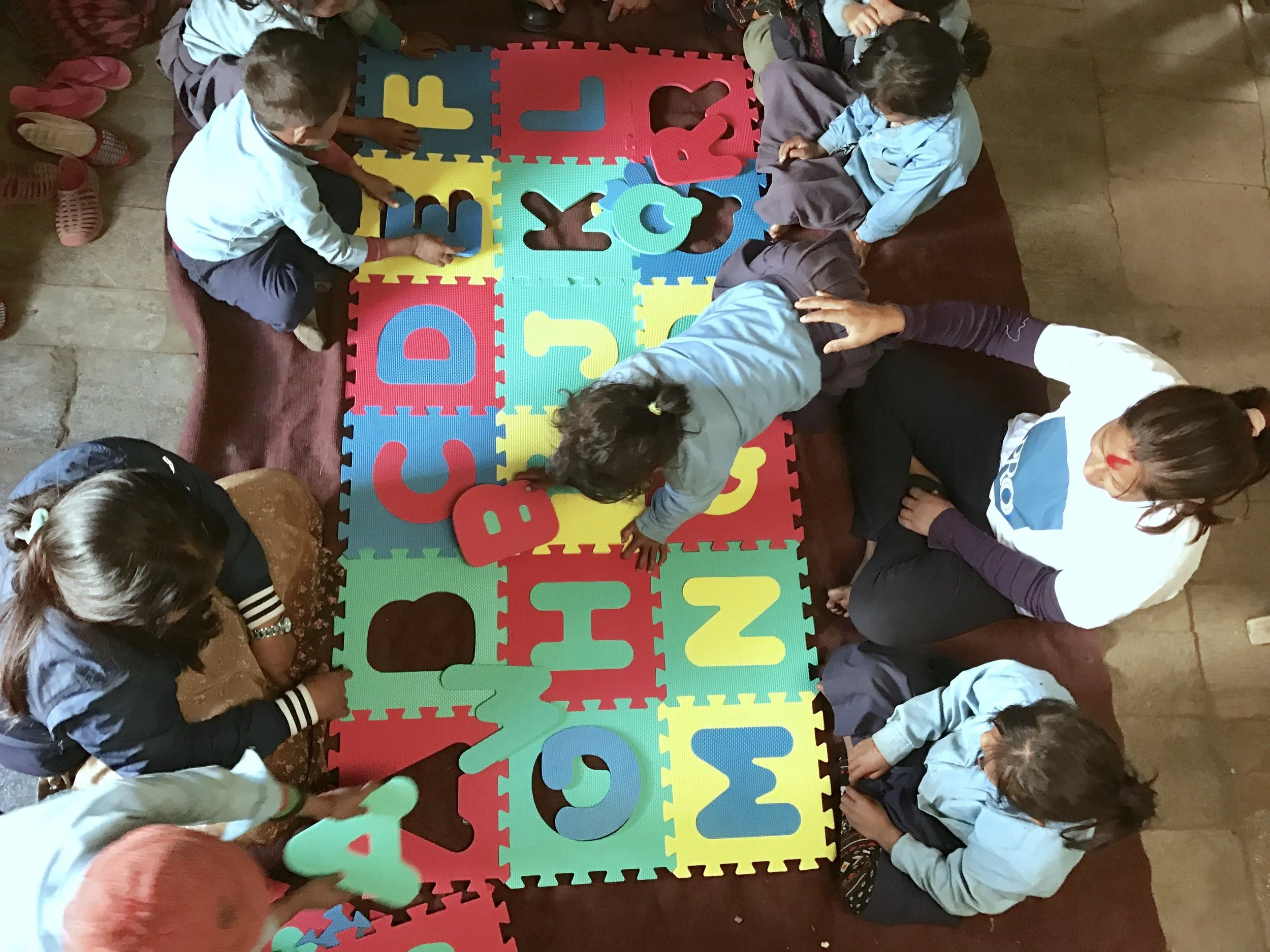 Alphabet group puzzle for the playgroup children of Uhiya in Gorkha district.