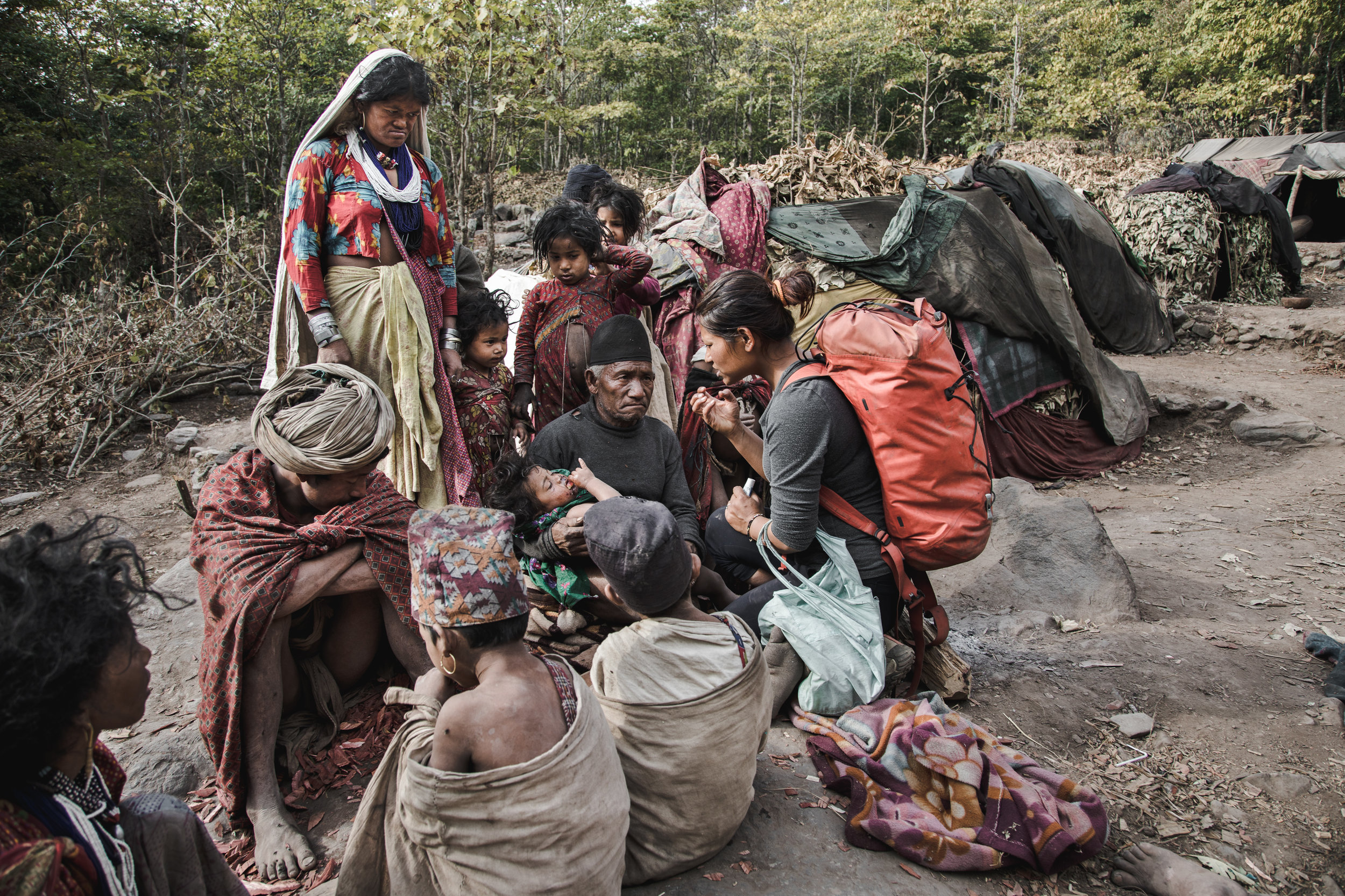 Samjhana giving First-Aid to a 3 year old child with eye-infection.