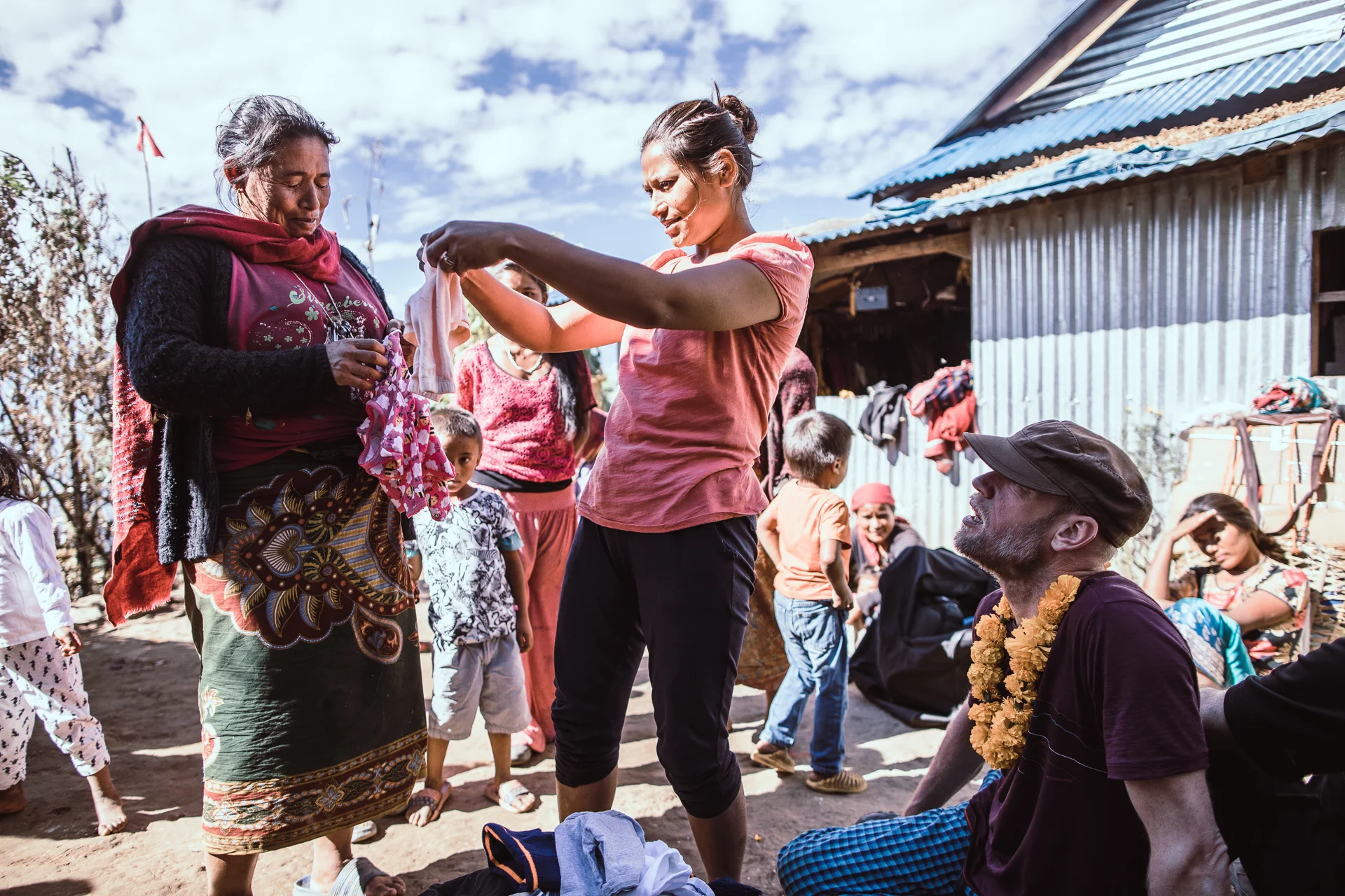 Samjhana and volunteer Harper Tromp handing over clothing at Ringmu.
