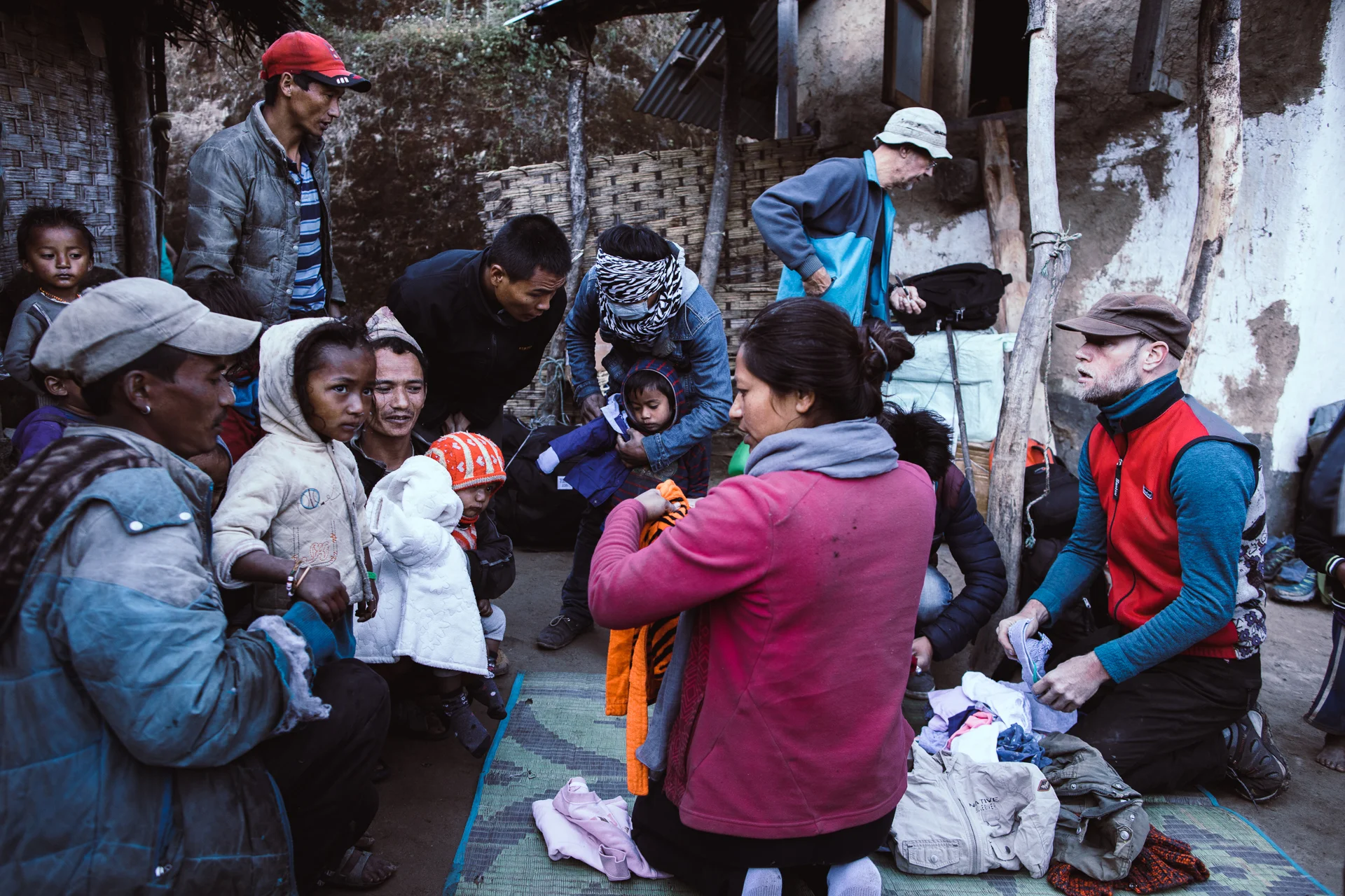 Samjhana and volunteer Harper Tromp handing over clothing at Firfire.