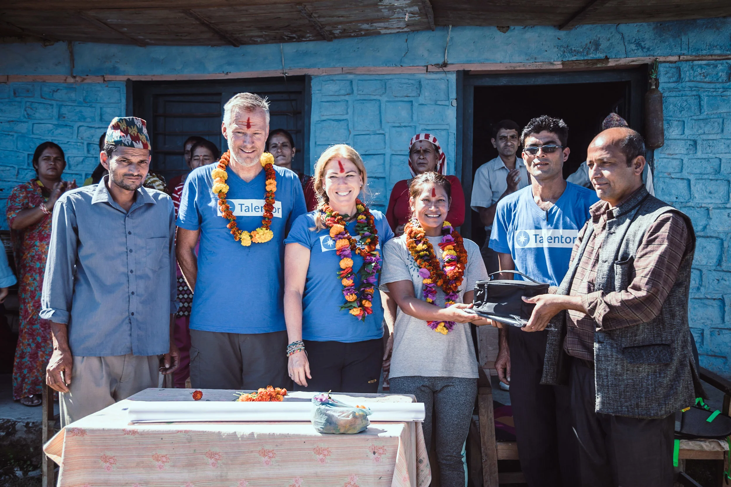 Handover of the IT material including a tablet, speaker and projector.