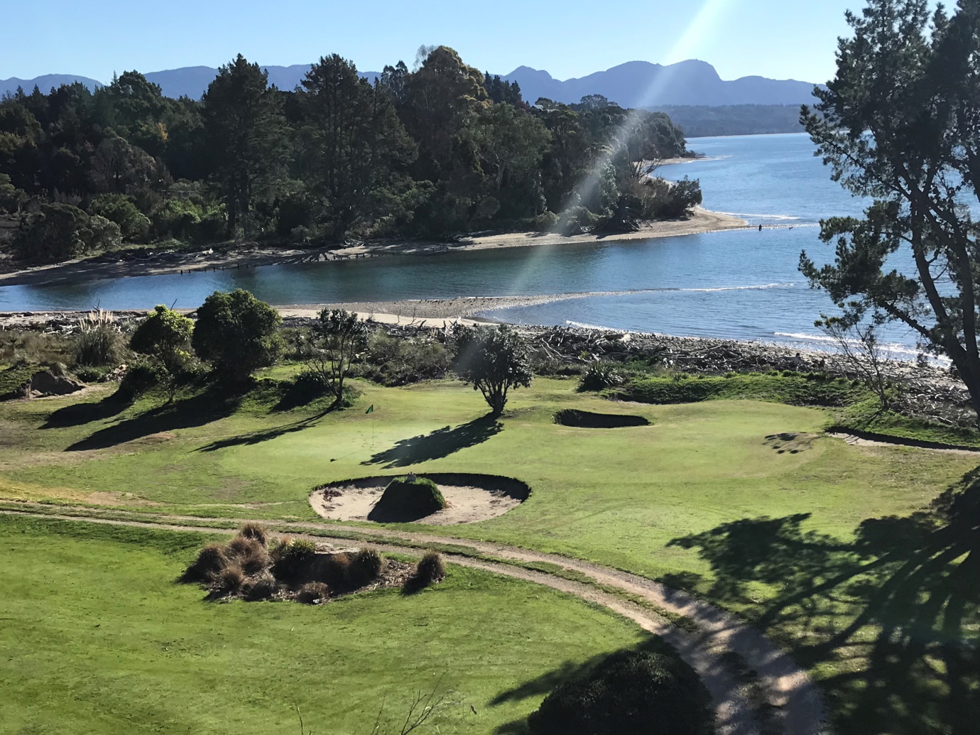 The 12th green – surrounded by 5 bunkers and ocean behind