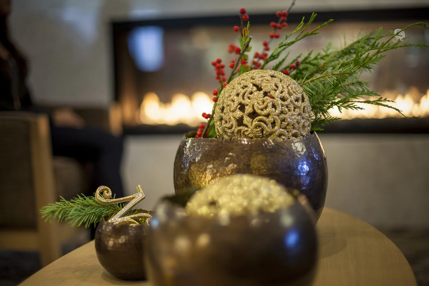 Photo styling of bowls and gold balls with berries and greenery.