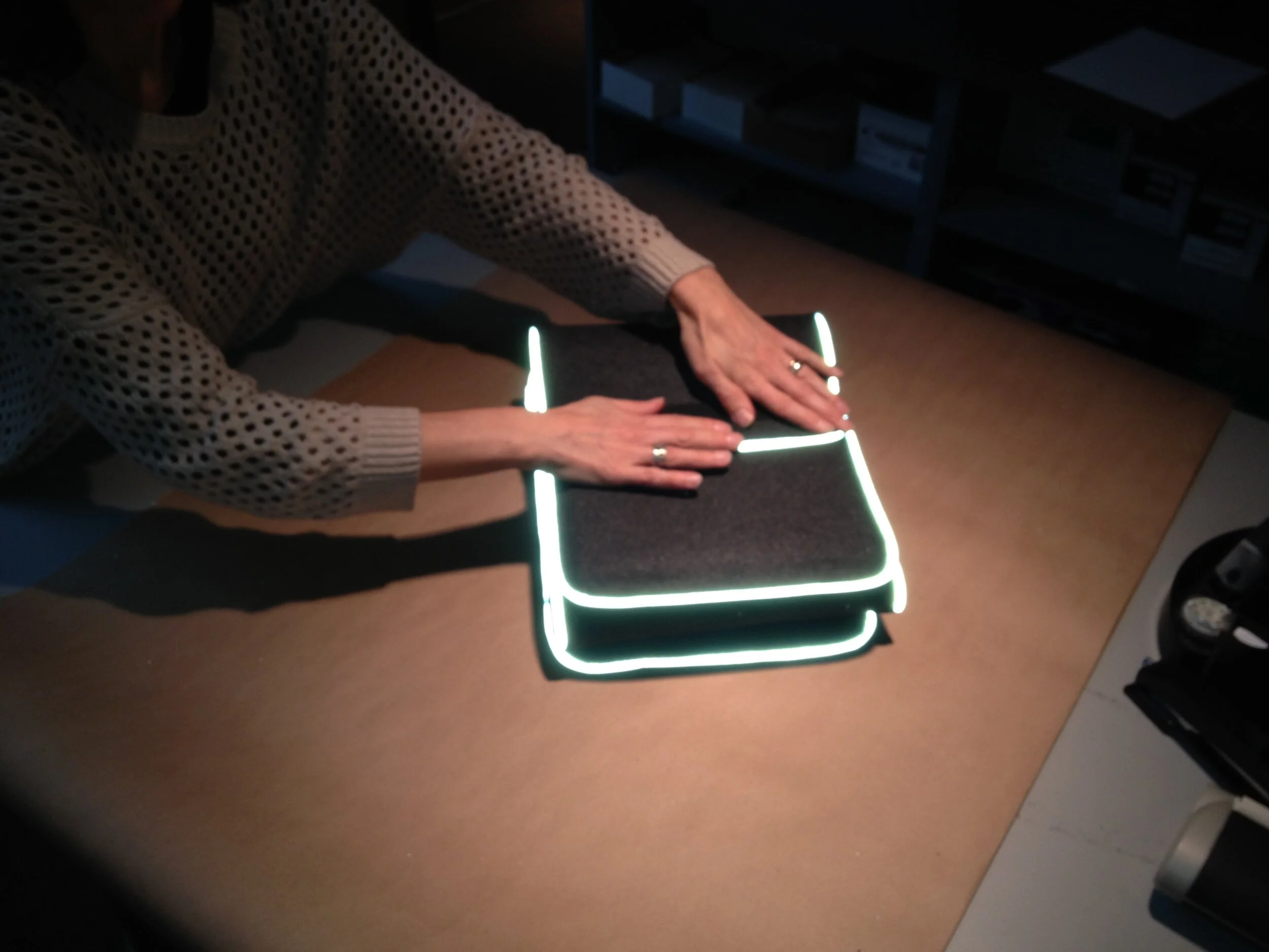 Laptop felt case showing reflective trim.