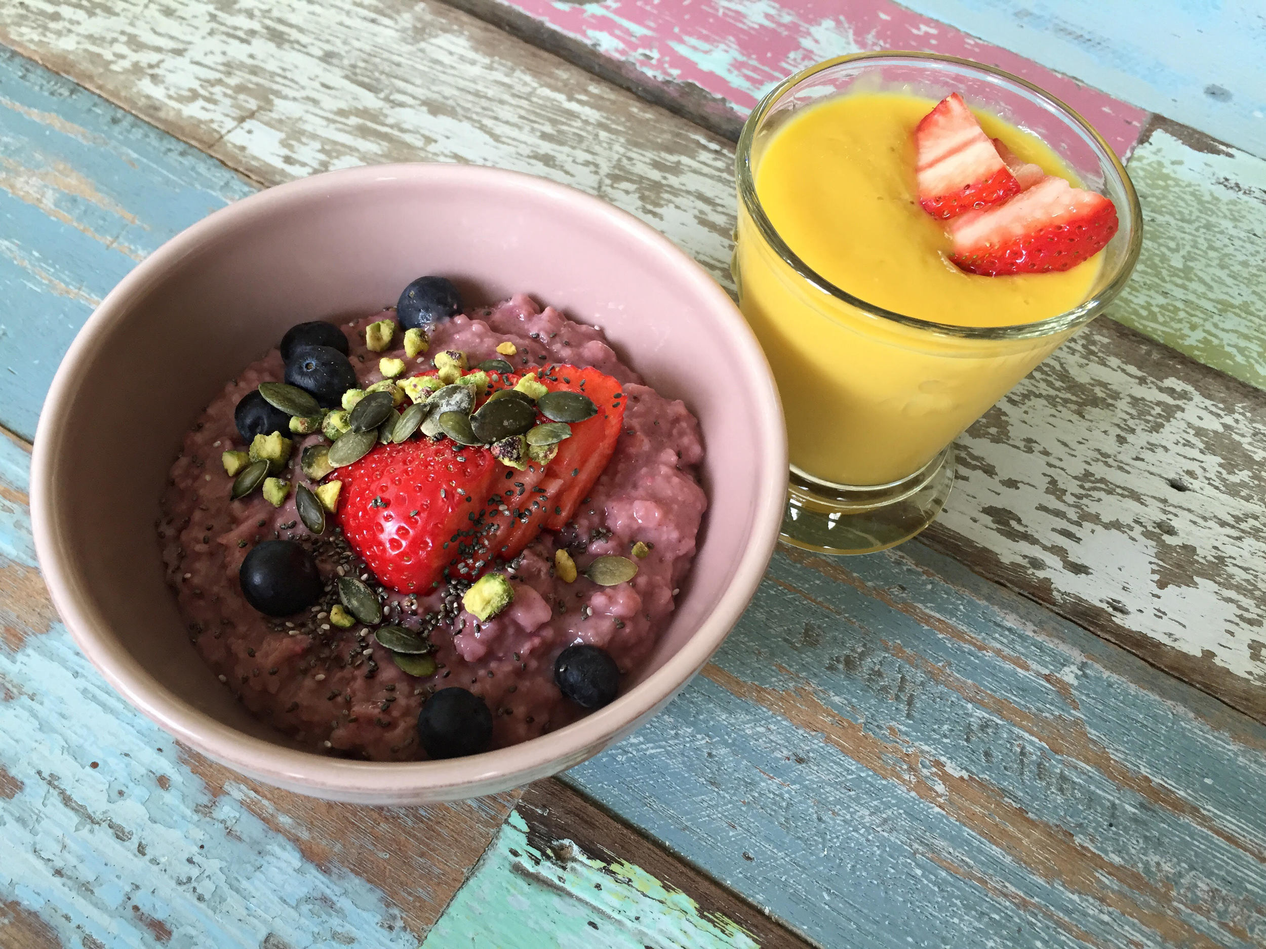 Breakfast of raw porridge oats soaked overnight in hemp milk and then stirred into raspberries and topped with berries, chia seeds and nuts. Mango, pineapple and banana smoothie!