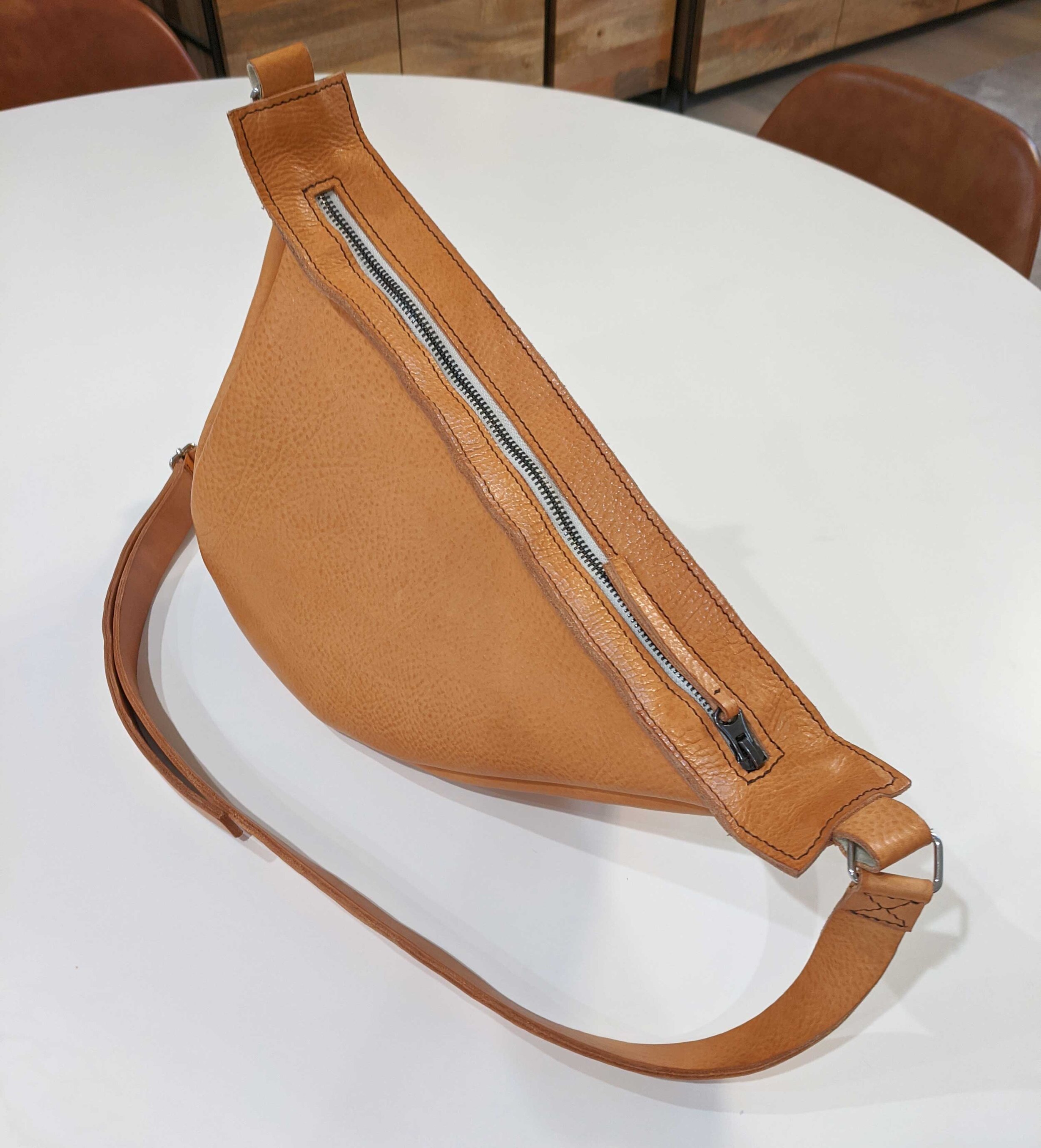 Beige-sling-bag-on-table.jpg