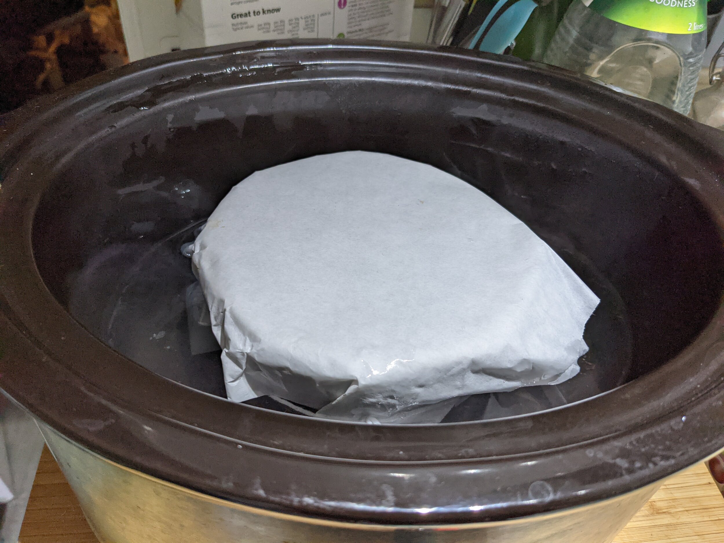 A 1 pint pudding cooking in a slow cooker