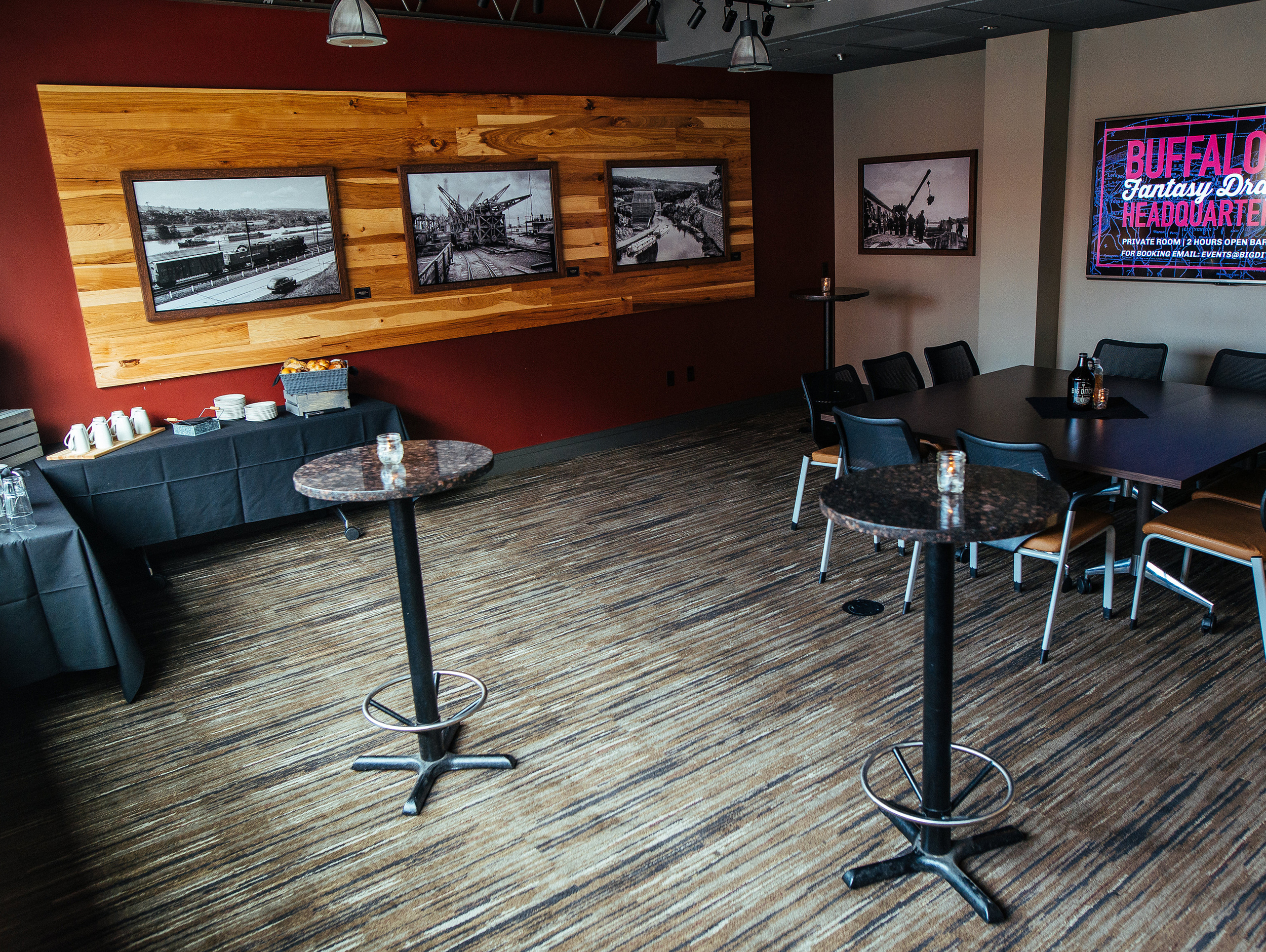 Canal Room with high top tables, food display and large TV