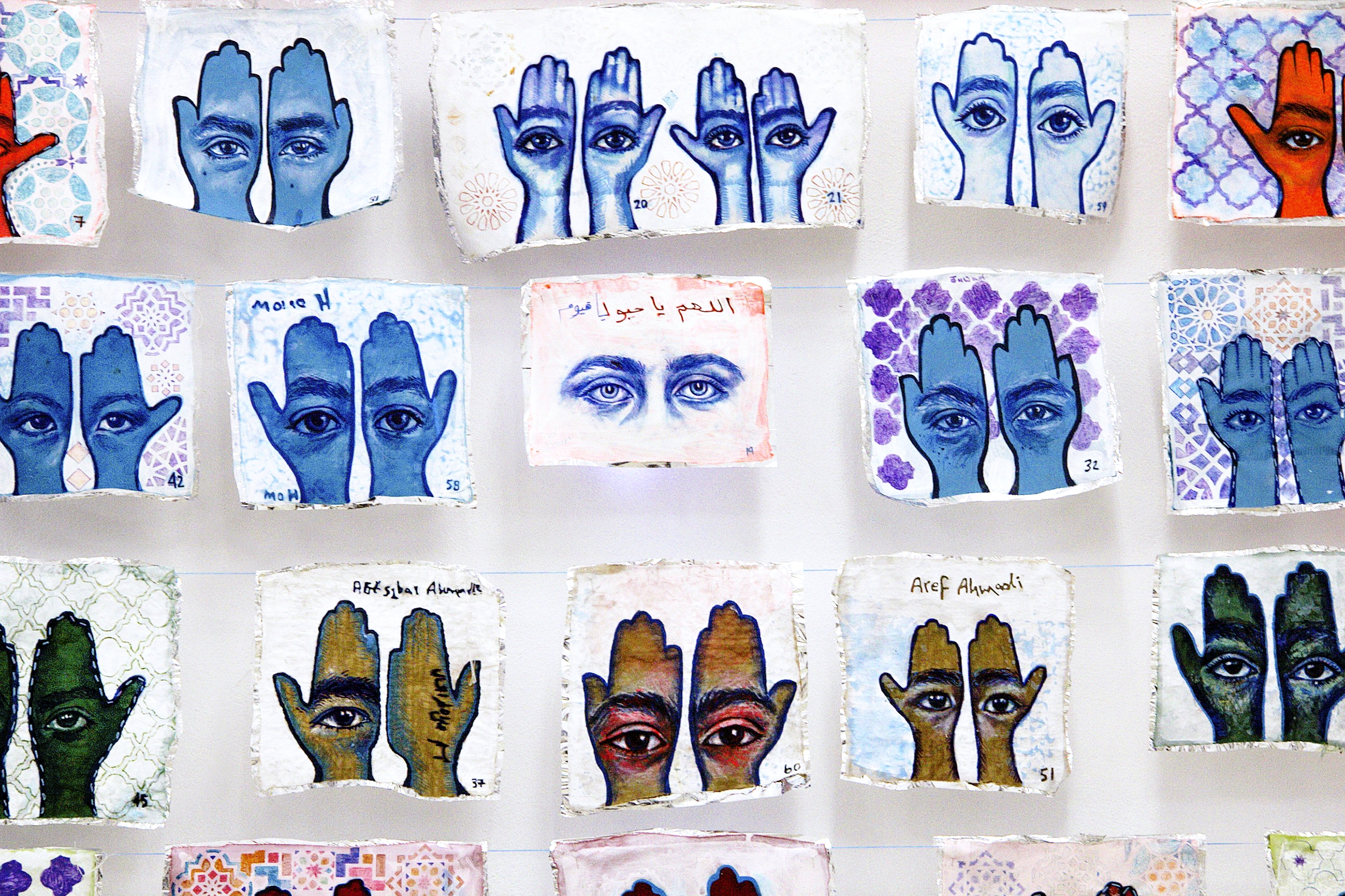Detail of 'Khamsa, Sadaqa Jaariyah (Endless Charity): The Refugee Crisis Portrait Project' at International Fine Arts Consortium (IFAC) Athina, 2016. Photo courtesy of artist.
