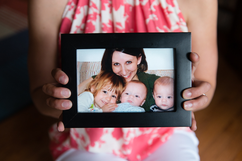 Powell holds a picture of her smiling with her three children during the time she was battling depression. “Looks can be deceiving,” said Powell. (Heidi De Marco / KHN)