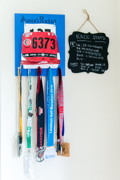 Competition medals and running stats hang in Powell’s house. She says fitness and working as a personal trainer contributed to overcoming her depression after giving birth to the twins. (HEIDI DE MARCO / KHN)