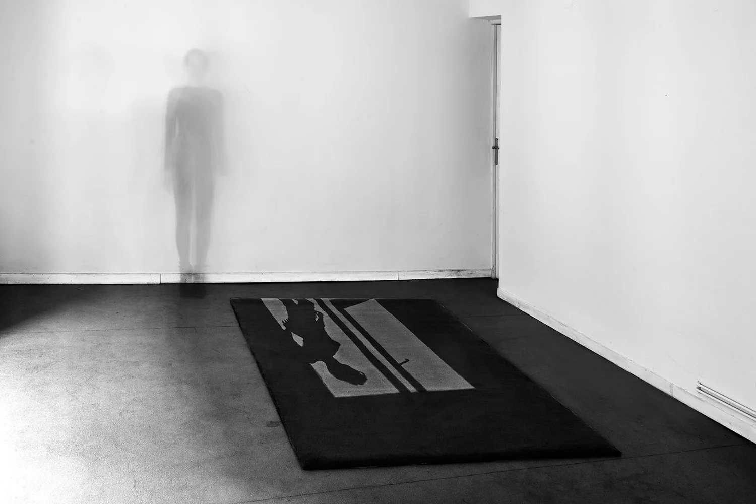 She was here is also a carpet that draws her shadow casted out of an unexisting window ..... also her foot prints are on the carpet