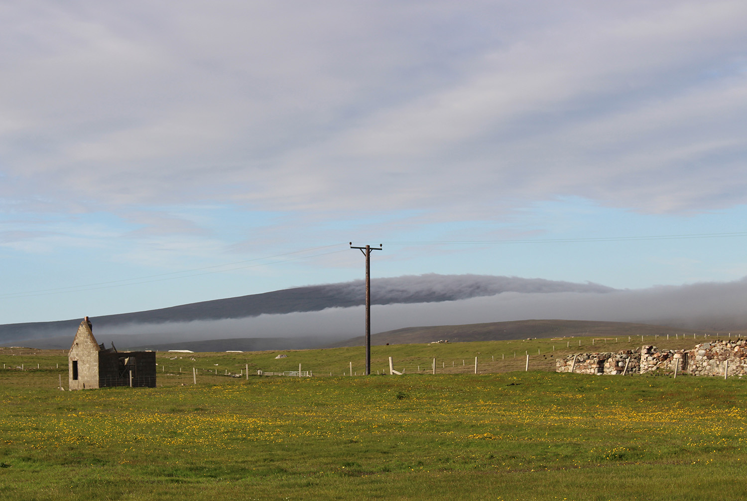 Dramatic contrast between the low cloud coming in and the dark heather of the hills beyond.