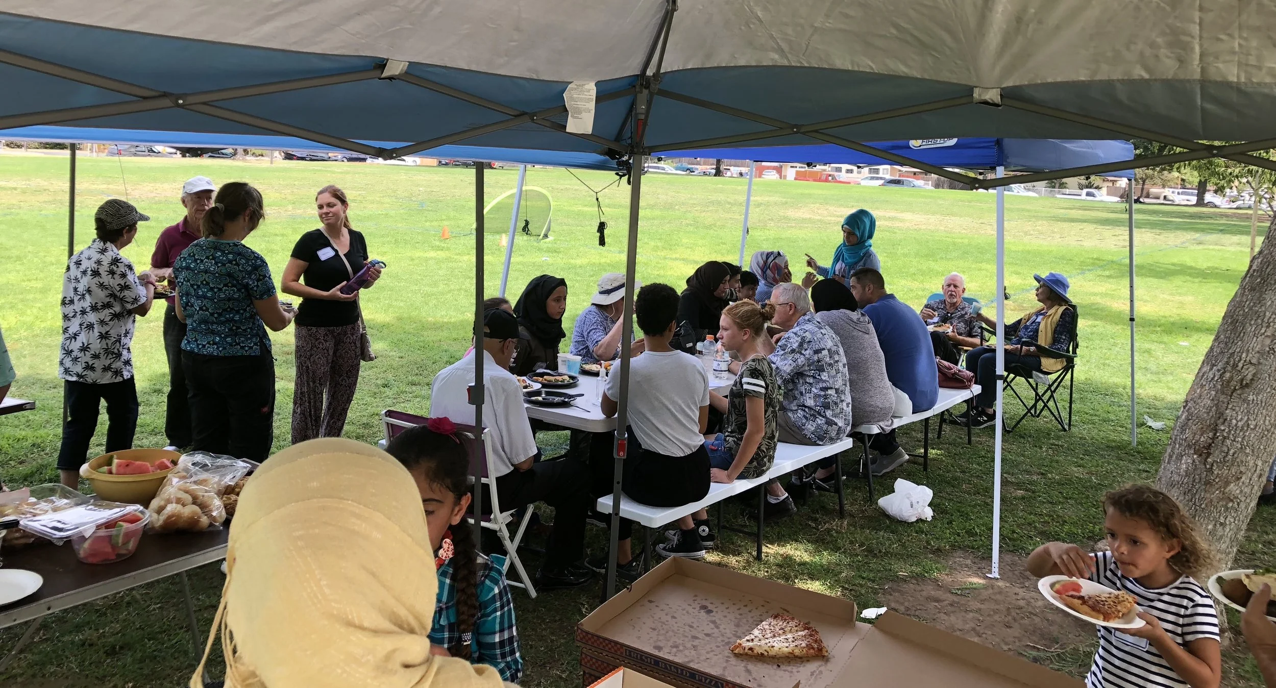 The group met with Syrian refugee families for a picnic at a local park.