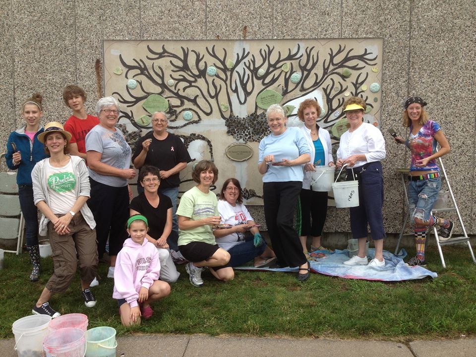 Group gathered around a mural