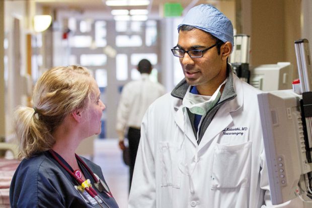 The late Dr. Paul Kalanithi speaks to a nurse at Stanford Hospital. Kalanithi's book "When Breath Becomes Air" is in the running for a Wellcome Book Prize. Photo by Norbert von der Groeben, Stanford Hospital and Clinics ( source )