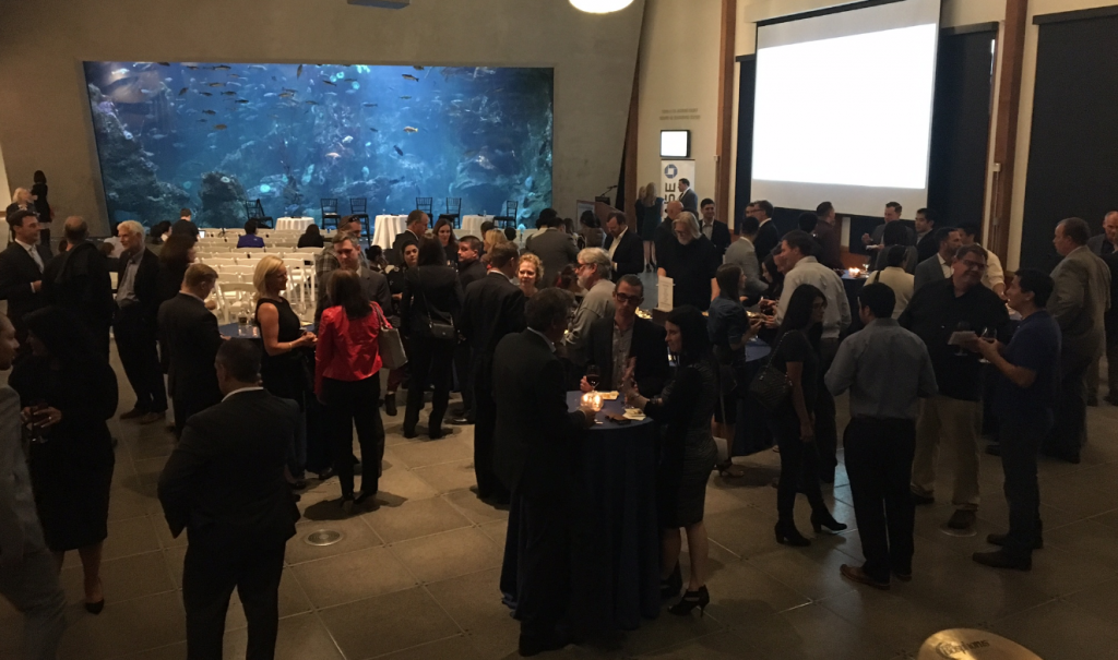 Guests mingle and discuss the topics presented by the panel.