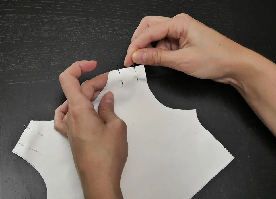 Pin your pieces together at the shoulders to preserve their alignment. Then run a seam in a straight line along each pinned edge.