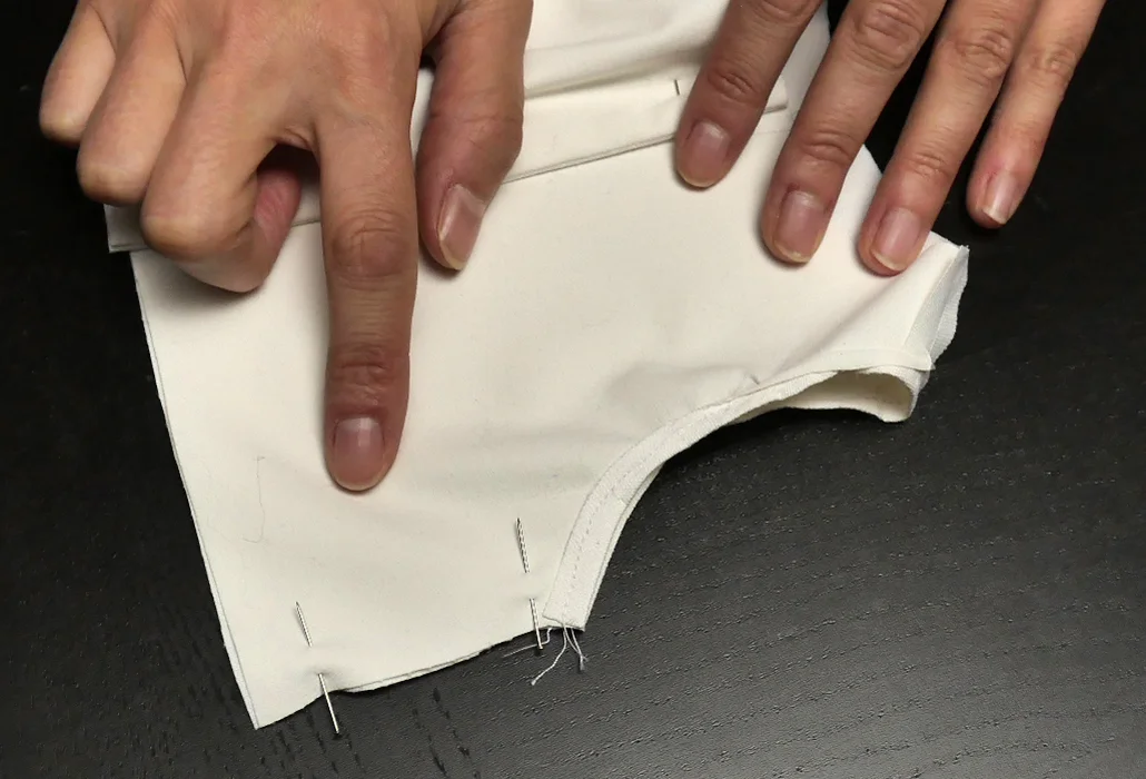 Prepare to run your side seams. The underarm hems should meet perfectly, while the raw edge along the shirt bottom might not.