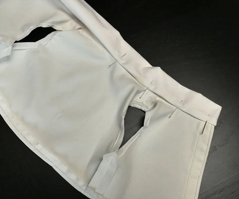 Fold the remaining raw edge of your collar toward the inside of your shirt. Pin it, and run a topstitch over the edge to secure it.