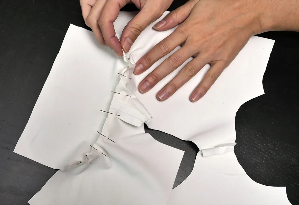 Pin and repin as often as it takes to make these curves follow each other. They should be the same length, unless the seam allowance at your shoulders is greater than 0.25 inches; in that case, try to center the sleeve while you pin it so that the excess fabric is equal at each end of this seam.