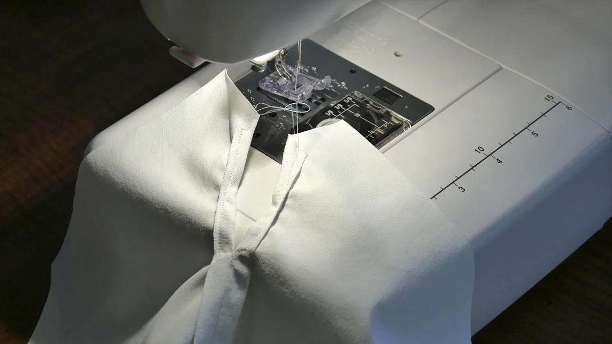Sew a finished edge around the hole in the back of the pants meant for the tail.