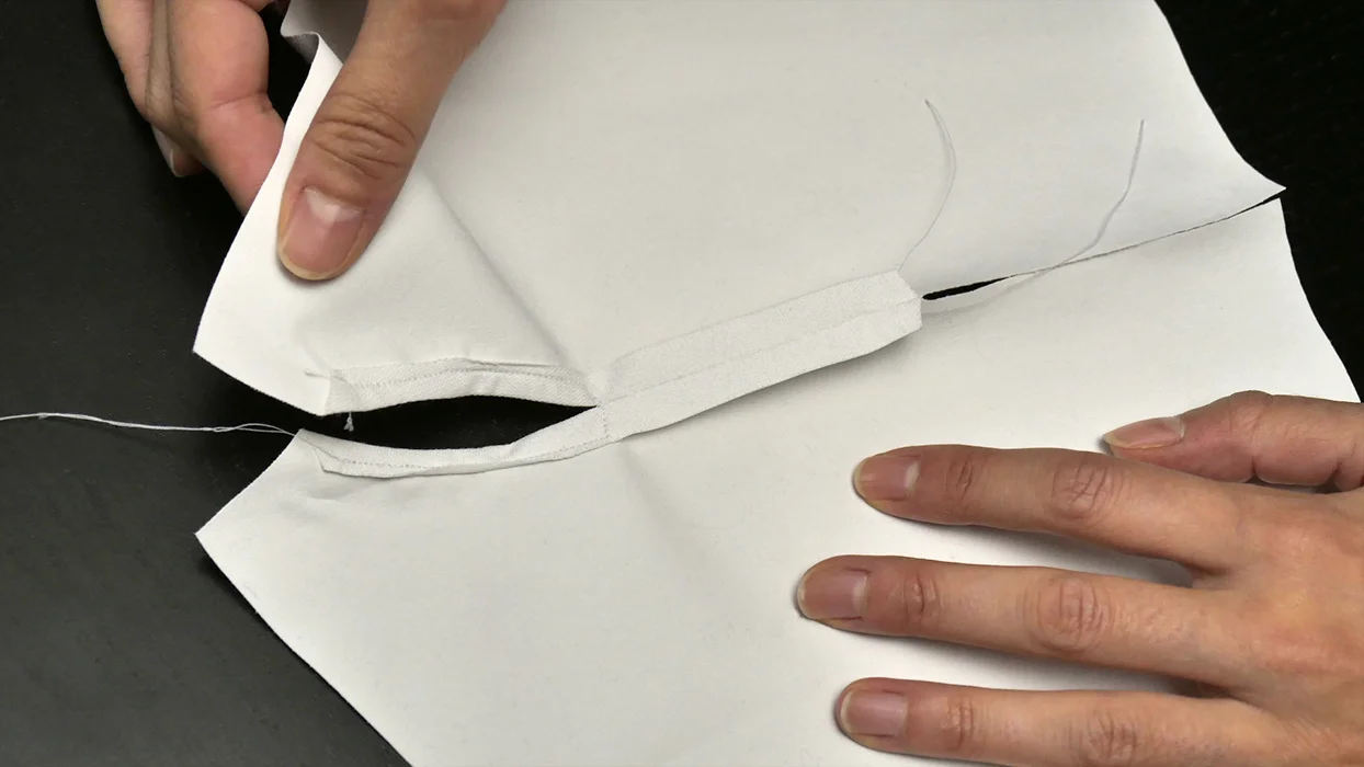 With a finished edge around the tail hole, it should look like this (while looking at the "wrong" side of the fabric).