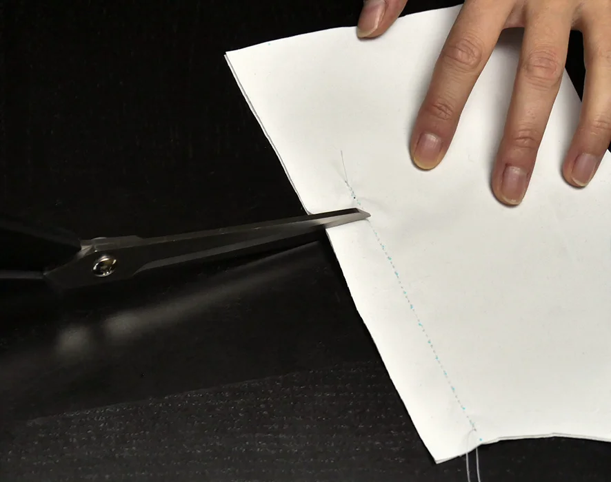 Before ironing, snip your fabric midway down the back. Be sure to provide a generous allowance near the end of your seam so the top of your back vent is less likely to fray or tear over time.