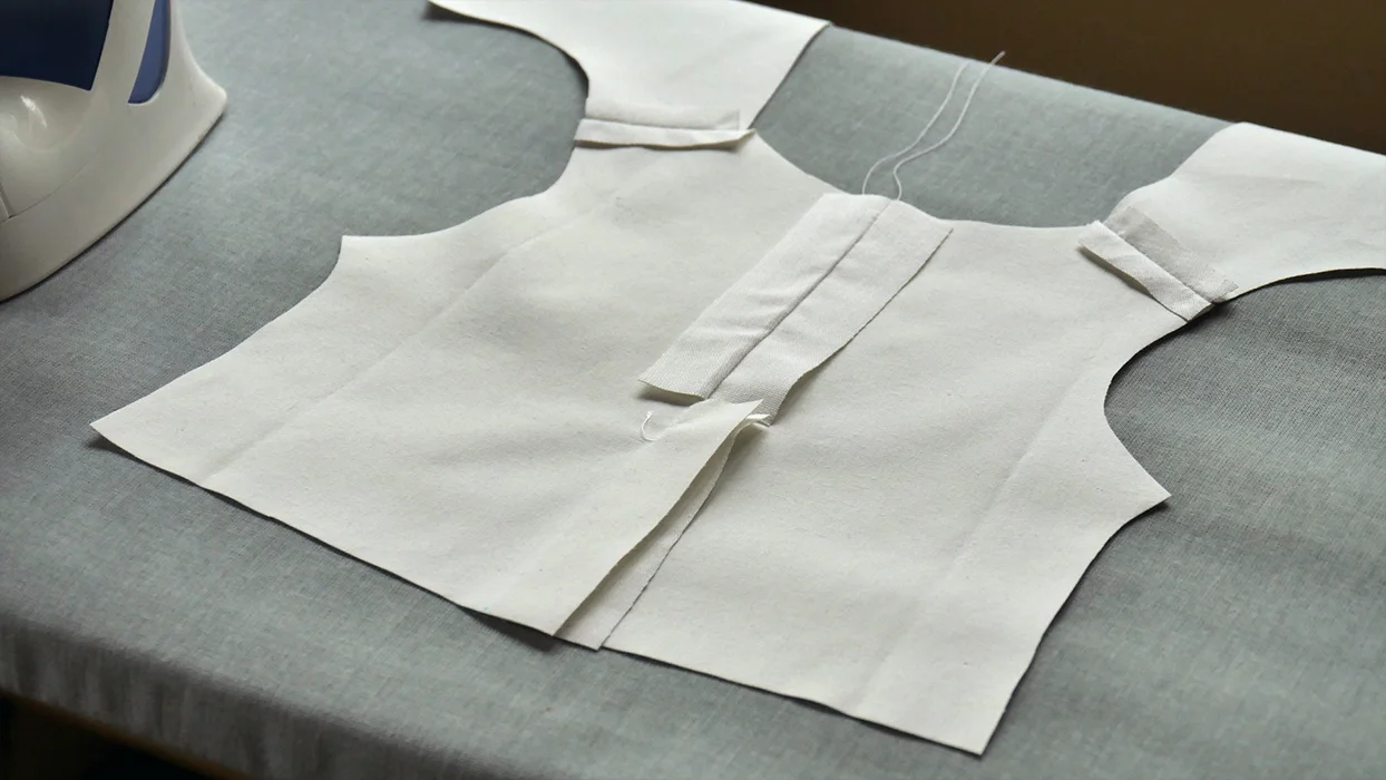 Open your back seam and press it flat. This is what your jacket should look like from the "wrong" side. Notice that I did not open the back vent! Press it over to one side or the other, so that one edge is folded under the overlapping edge.