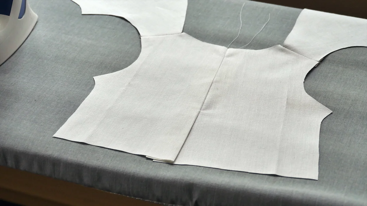 Open your back seam and press it flat. This is what your jacket should look like from the "right" side. Notice that I did not open the back vent! Press it into a neatly folded line down the center of the back with a little bit of overlap.