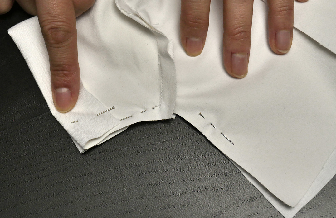 You'll want to keep a pin or two in the cuff for a bit longer, but you should remove all the other pins so that you can open the jacket and lay it flat.