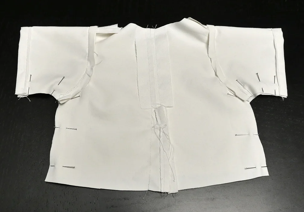 Use pins to keep each side in alignment as you prepare to run these seams. The edges of your cuffs should line up perfectly, but your raw hemline might not. That's okay!