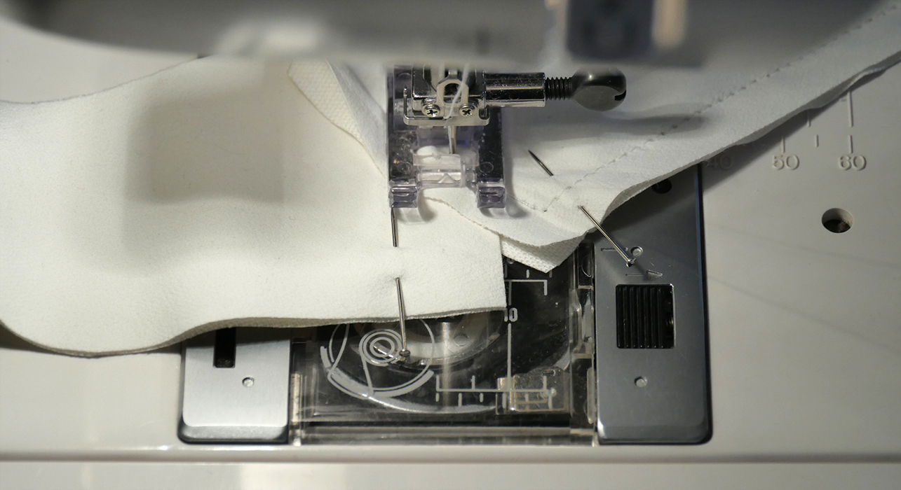 Pay particular attention to this corner turn on your seam. The angle of this corner should be centered on the existing seam. To make the turn, plunge the needle in at the point your new seam meets the existing seam, then lift the presser foot and pivot your whole lapel.