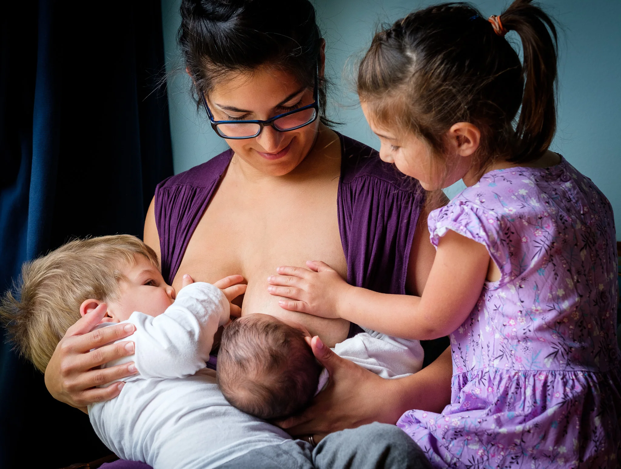“When I first began my breastfeeding journey, I could never have imagined where it would take me. I came into it with so many preconceptions about how, when, why and for how long I wanted to breastfeed my baby girl. Here I am 3 1/2 years later, having learned so much. Though I never imagined myself nursing a toddler or even two children at once, I’m glad that this is the path we took, as it’s always been the easiest option for me. I feel my children have a stronger relationship for it and I wouldn’t change a thing.” ~ Anastasia with her children, James, Zoe, and Lauren