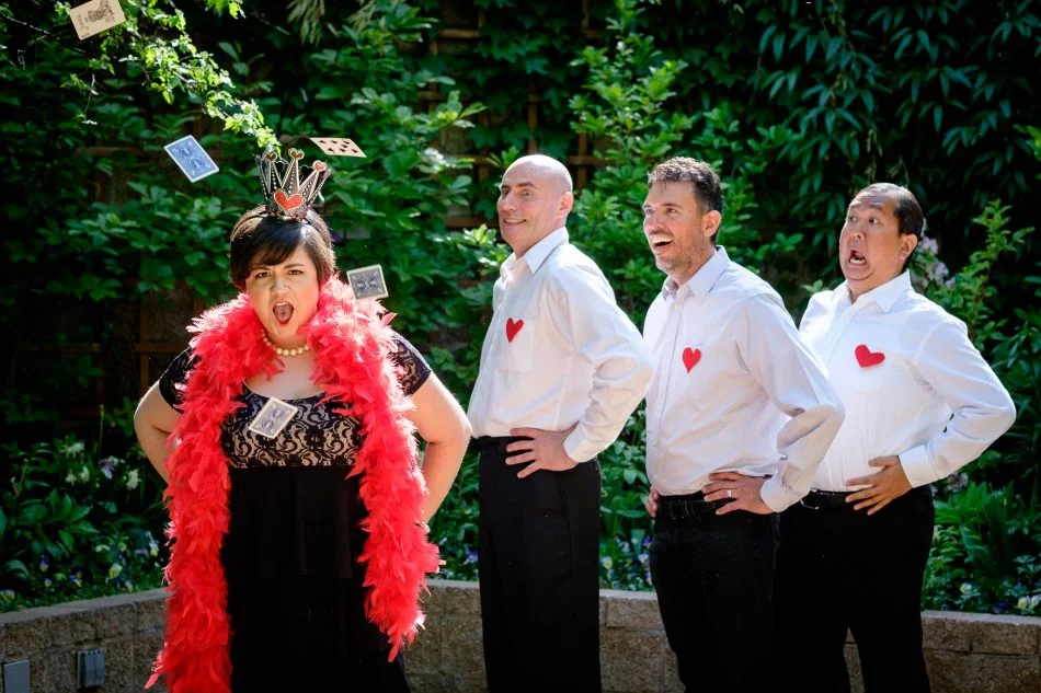 queen of hearts with cards flying in the air