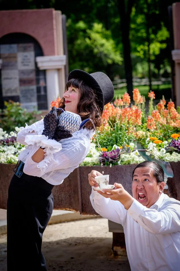man catches tea from mad hatter